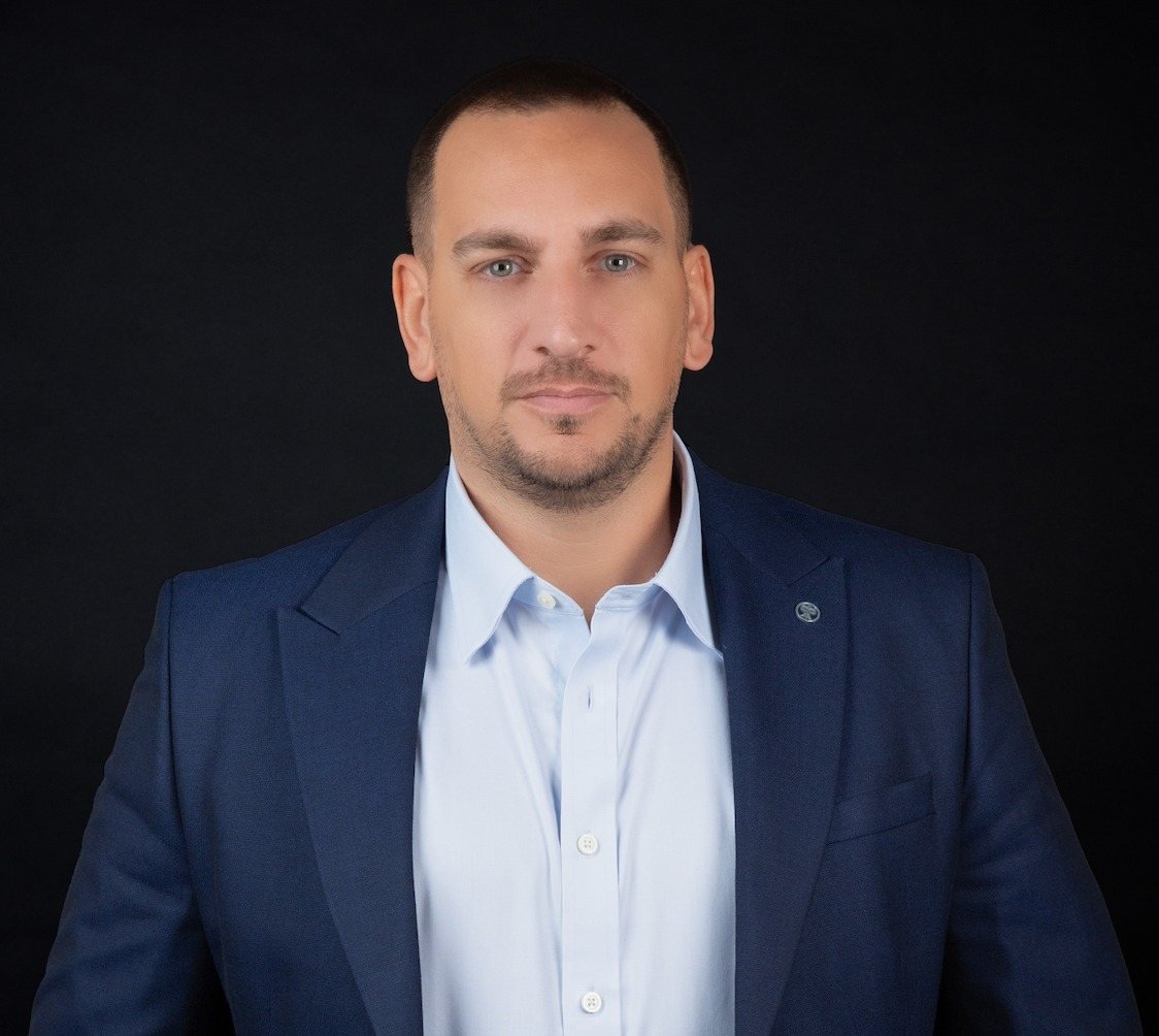 Portrait of Dr. Riad Al Chami in a navy suit